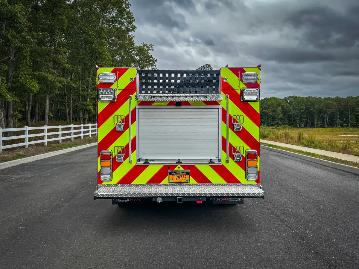 Straight rear exterior view showing chevron striping and rear roll-up door.